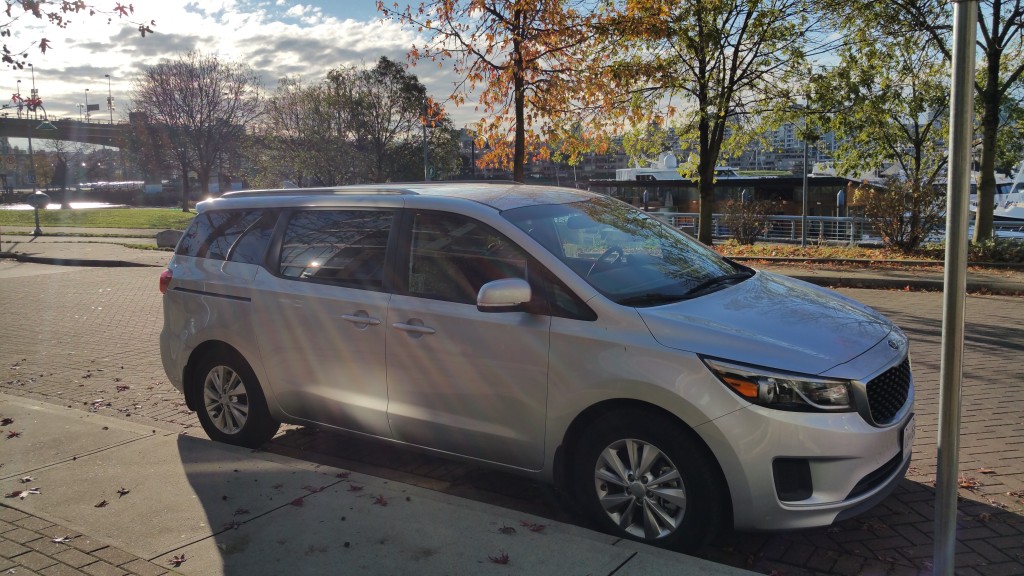This is a 2015 Kia minivan, part of the Modo carshare. It costs just $8/hour to rent!