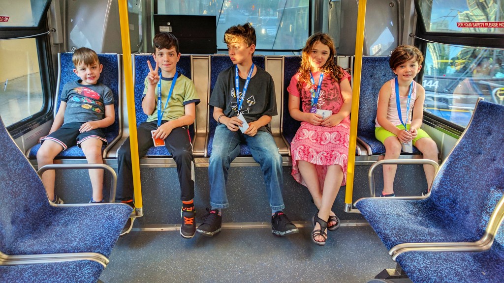 The kids (including the littlest one), chilling at the back of the bus, on our way to English Bay.